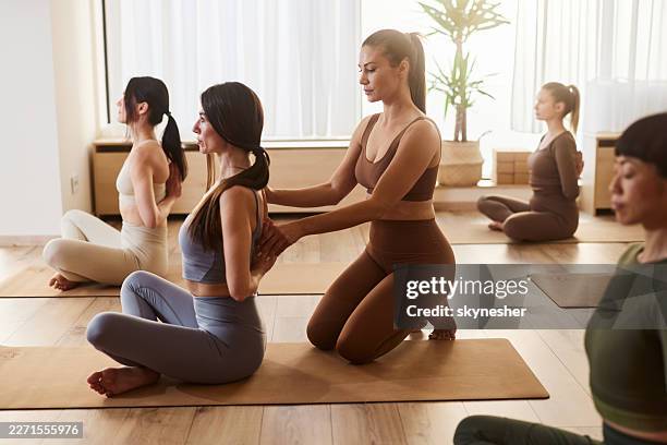 assistance on yoga class! - yoga instructor stock pictures, royalty-free photos & images