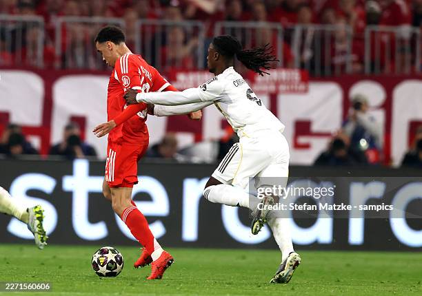 Jamal Musiala of FC Bayern Muenchen is tackled by Eduardo Camavinga of Real Madrid during the UEFA Champions League 2025/26 Quarter-Final Second Leg...