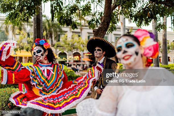 young woman dancing and celebrating the day of the dead outdoors - mexican hat dance stock pictures, royalty-free photos & images
