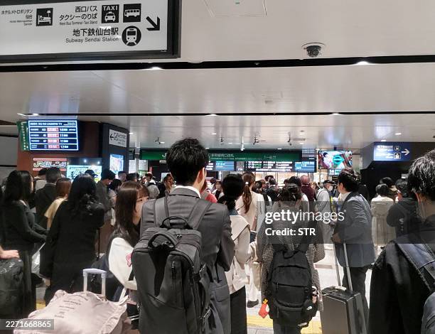 This photo shows a general view of a crowded railway station as the Shinkansen services are suspended after an earthquake hit northern Japan, in...