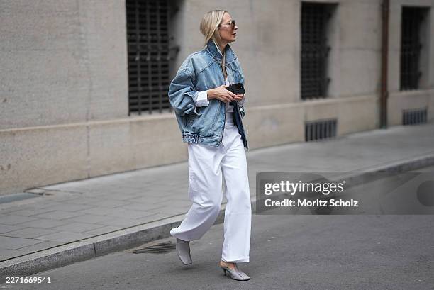 Mirja Klein is seen wearing a light south blue denim oversized bomber jacket with an elasticated hem, buttoned cuffs and a pointed collar from Saint...