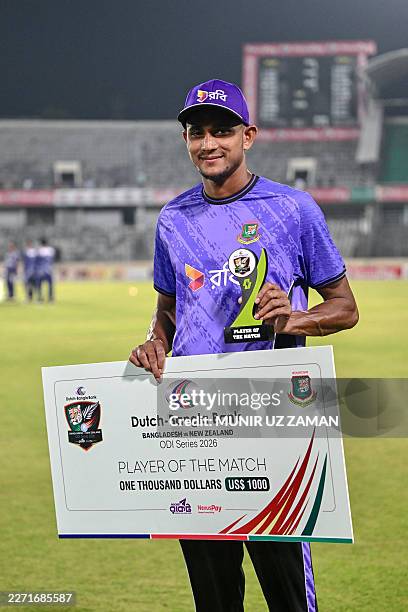 Bangladesh's Nahid Rana poses with the player of the match trophy at the end of the second one-day international cricket match between Bangladesh and...