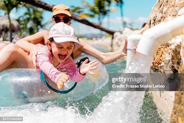 kleines mädchen hat während der sommerferien mit ihrer mutter spaß auf dem wagen - freibad stock-fotos und bilder