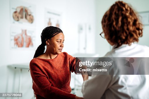 Woman having blood pressure checked by female doctor Woman having blood pressure checked by female doctor