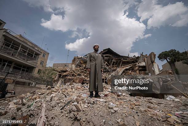 An Iranian cleric poses for photographs while standing on the ruins of a synagogue in Tehran, Iran, on April 20, 2026.