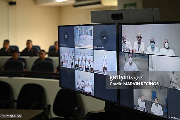 Monitors broadcast the mass hearing against alleged leaders of the Mara Salvatrucha at the Judicial Center Against Organized Crime in Soyapango, El...