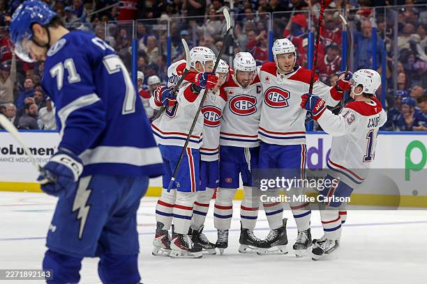 Members of the Montréal Canadiens celebrate a goal as Anthony Cirelli of the Tampa Bay Lightning reacts during the first period of Game Two of the...