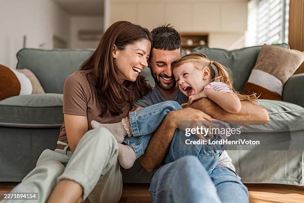 happy family bonding and laughing together at home - familia imagens e fotografias de stock