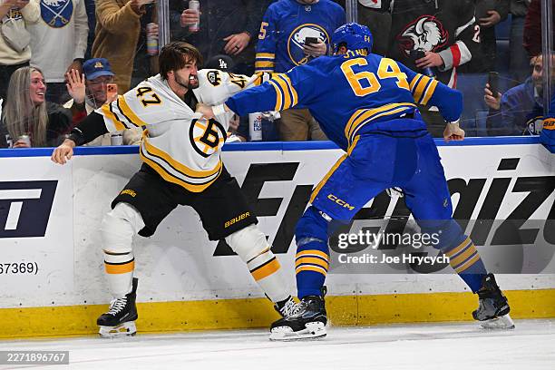 Logan Stanley of the Buffalo Sabres and Mark Kastelic of the Boston Bruins fight during the third period in Game Two of the First Round of the 2026...