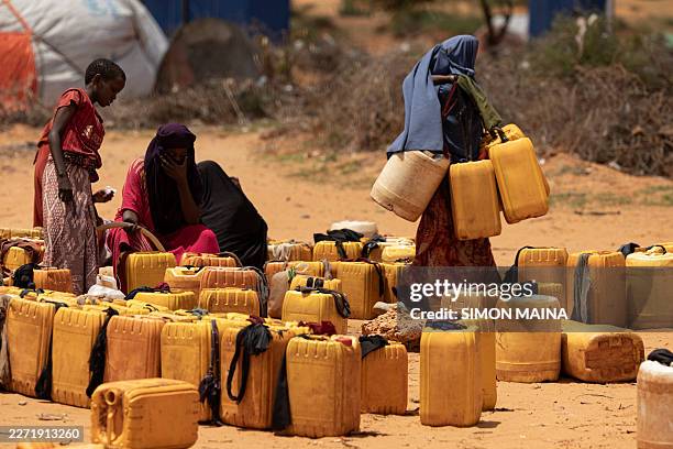 Displaced Somali people collect water from a well inside a camp for internally displaced persons in the outskirts of Kismayo town, on April 21, 2026....