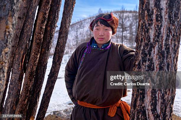 mongolian boy wearing traditional deel in winter landscape - mongolian people stock pictures, royalty-free photos & images