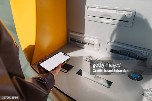 person using smartphone for contactless atm banking transaction - digital currency stock pictures, royalty-free photos & images