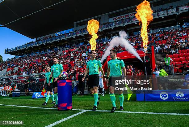 Referees lead the players ouduring the round 25 A-League Men match between Adelaide United and Macarthur FC at Coopers Stadium, on April 19 in...