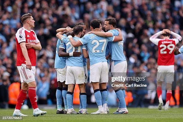 Players of Manchester City celebrate following victory in the Premier League match between Manchester City and Arsenal at Etihad Stadium on April 19,...