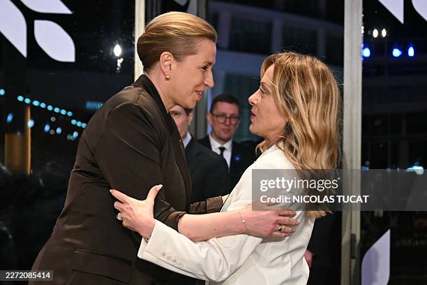 Denmark's Prime Minister Mette Frederiksen embraces her Italian counterpart Giorgia Meloni during the working dinner ahead of an informal meeting of...