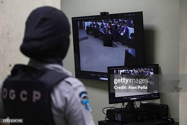Prison officer stands guard during a massive hearing against criminals and gang members at CECOT on April 23, 2026 in Tecoluca, El Salvador. In 2023,...