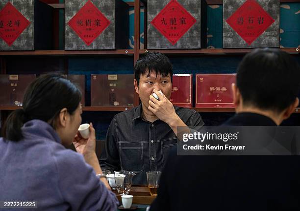 Vendor tastes fine tea with potential customers at the 20th Beijing International Tea and Tea Ceremony Exhibition on April 20, 2026 in Beijing,...