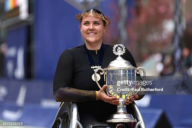 Eden Rainbow-Cooper of Great Britain poses with the trophy after winning first place in the women's wheelchair race during the 130th Boston Marathon...