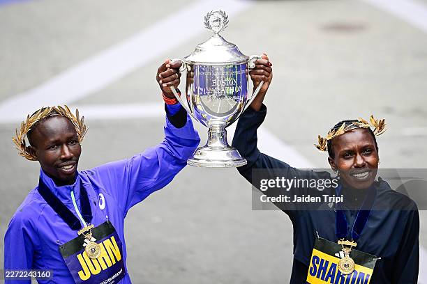 John Korir of Kenya and Sharon Lokedi of Kenya pose for a portrait during a trophy presentation after taking first place in the men's and women's...