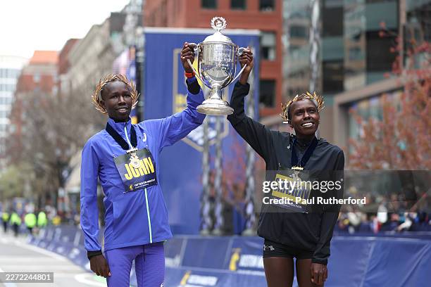 John Korir of Kenya and Sharon Lokedi of Kenya pose with the trophy after winning the Men's and Women's division at the 130th Boston Marathon on...