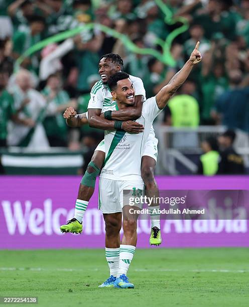 Galeno of Al Ahli celebrates scoring his team's first goal with teammate Zakaria Hawsawi during the AFC Champions League Semi Final match between...