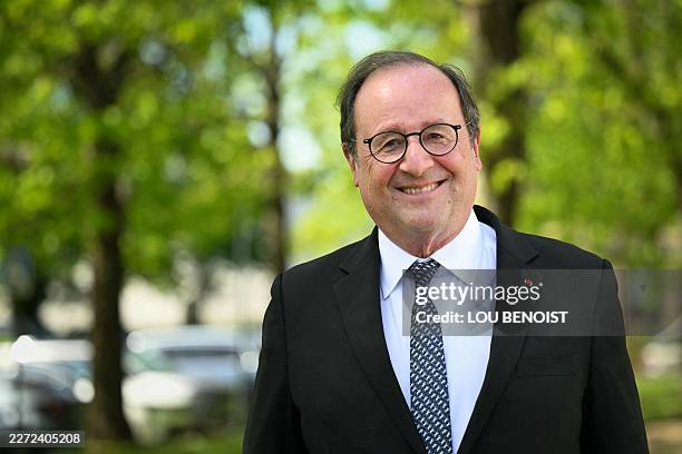 France's former President, Socialistes et Apparentes' MP Francois Hollande poses for portraits within a meeting of various figures of the left named...