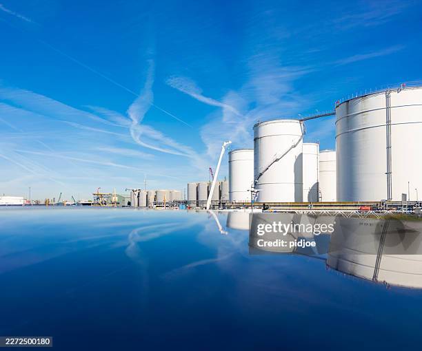 white fuel tanks in reklection. - fuel storage tank stock pictures, royalty-free photos & images