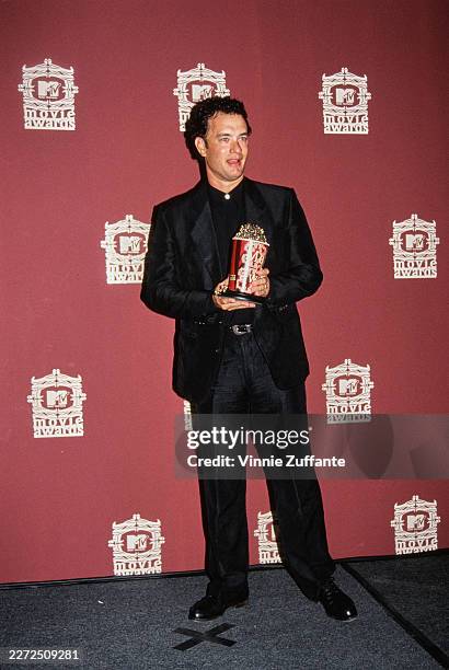 American actor Tom Hanks, wearing a black blazer over a black shirt with black trousers, in the 3rd Annual MTV Movie Awards press room, at Sony...