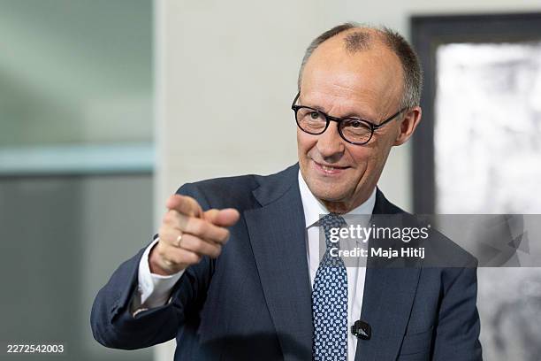 German Chancellor Friedrich Merz chats with female high school students during the annual Girls' Day event at the Chancellery on April 22, 2026 in...