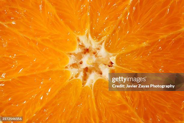 bright orange citrus fruit slice macro texture - orange slice stock pictures, royalty-free photos & images