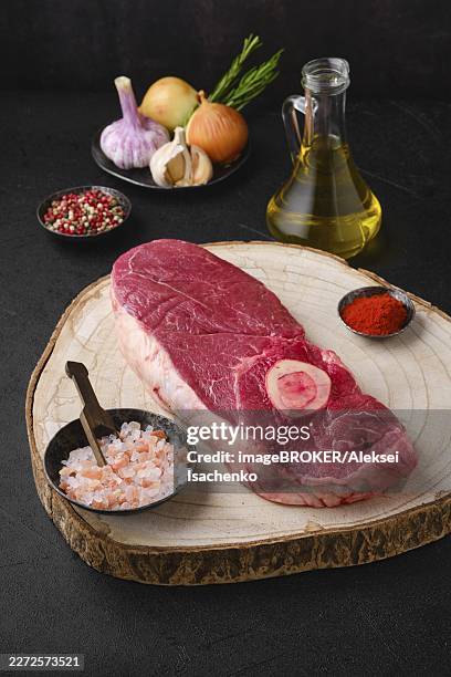 raw chuck eye steak on kitchen table ready for cooking - chuck steak stock pictures, royalty-free photos & images