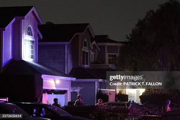Tactical agents leave a house associated with the suspected White House Correspondents' Dinner shooter after making entry at the residence in...