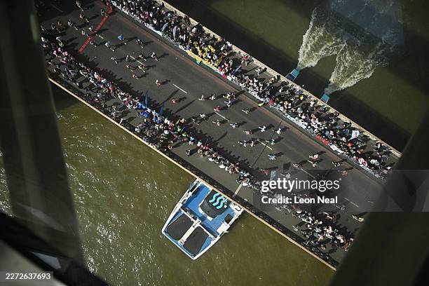 Runners race beneath the glass viewing walkway of Tower Bridge during the 2026 London Marathon on April 26, 2026 in London, England. Over 59,000...
