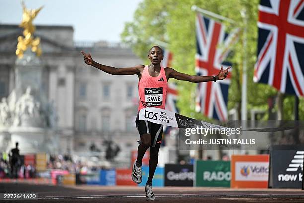 Kenya's Sabastian Sawe crosses the line to win the men's race in a new world record time at the 2026 London Marathon in central London on April 26,...