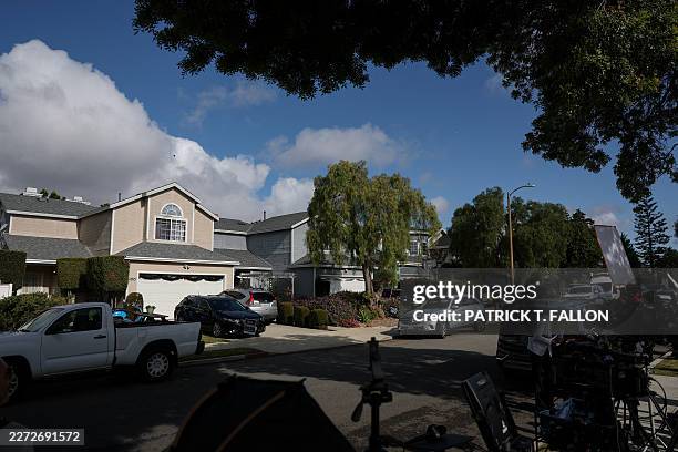 Members of the press work across the street from a home associated with the suspected White House Correspondents' Dinner shooter in Torrance,...