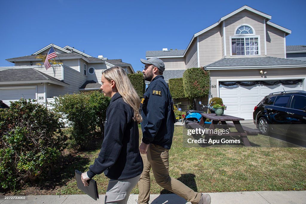 Terrence Cook Fbi FBI agents walk by the house believed to be linked to the suspect in ...
