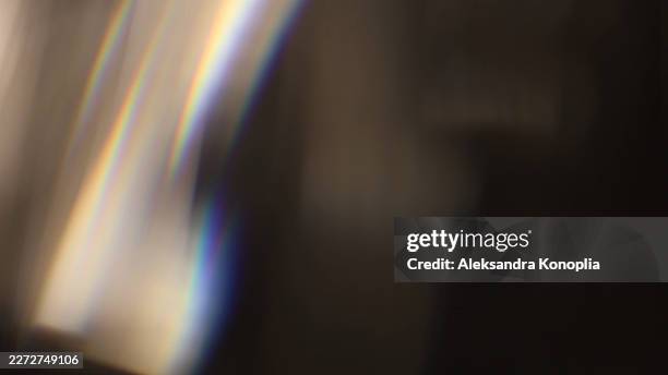 real prismatic rainbow light leak with soft analog lens flare on black and beige background - distress flare stock pictures, royalty-free photos & images