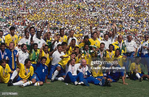 Players and staff of the Brazil national football team celebrate their 4th World Cup title by gesturing with a four finger sign after winning the...