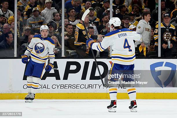 Noah Ostlund of the Buffalo Sabres celebrates with Bowen Byram after scoring a goal against the Boston Bruins during the third period Game Three of...