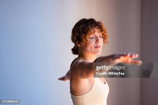 woman practicing yoga balance pose with closed eyes - good posture stock pictures, royalty-free photos & images