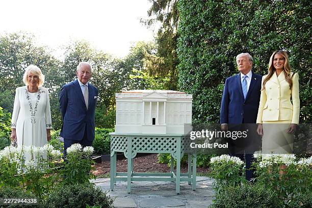 Queen Camilla and King Charles III pose with U.S. President Donald Trump and first lady Melania Trump alongside a replica beehive at the White House...