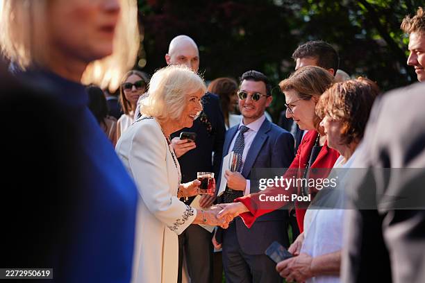 Britain's Queen Camilla speaks with guests during a garden party at the British Embassy on day one of King Charles III and Queen Camilla's State...
