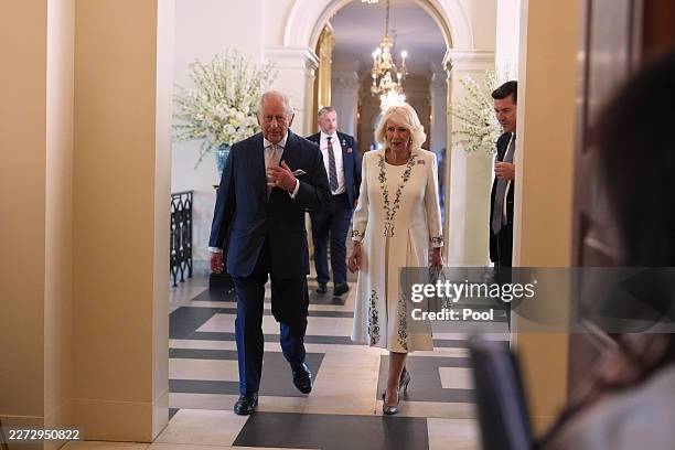 Britain's King Charles III and Queen Camilla enter the Ambassador's Library in the British Embassy on day one of their State Visit to the United...