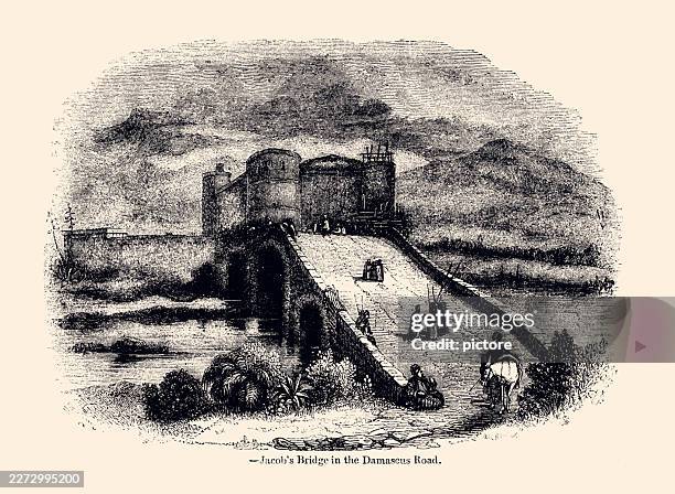 this 19th-century engraving depicts jacob’s bridge on the damascus road. it shows a large stone bridge with arches rising toward a medieval fortress with round crenellated towers.the river is the jordan river, - border crossing stock illustrations