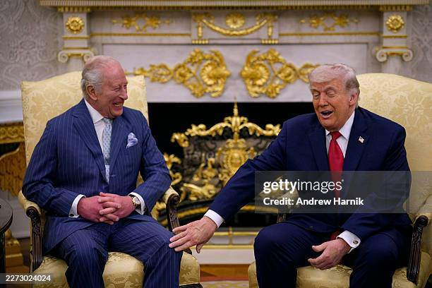 President Donald Trump touches King Charles III during a meeting in the Oval Office of the White House on April 28, 2026 in Washington, DC. King...