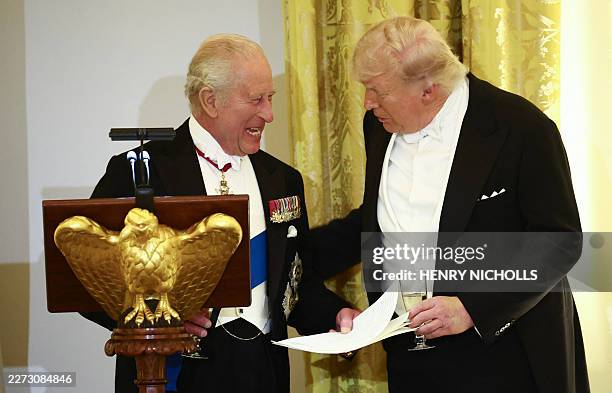 President Donald Trump and Britain's King Charles III smile as they talk during a State Dinner in the East Room of the White House in Washington, DC,...