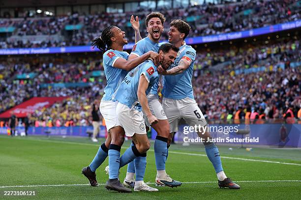Nico Gonzalez of Manchester City celebrates scoring his team's second goal with teammates Nathan Ake, Bernardo Silva and John Stones during the...