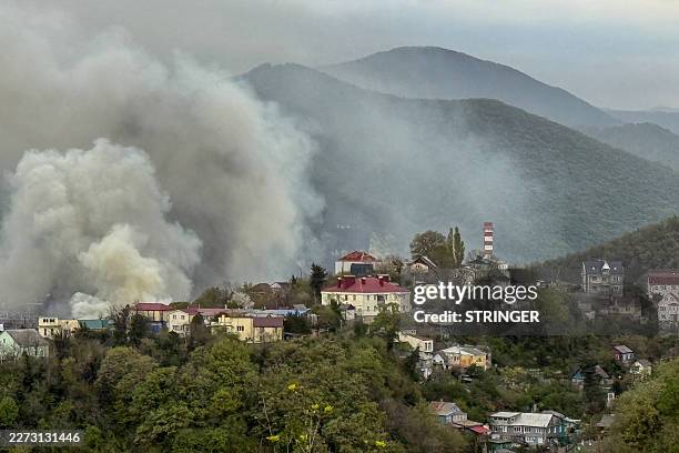 Smoke rises above buildings following a recent drone attack on the Tuapse oil refinery in Tuapse, Krasnodar region on April 29 amid the ongoing...