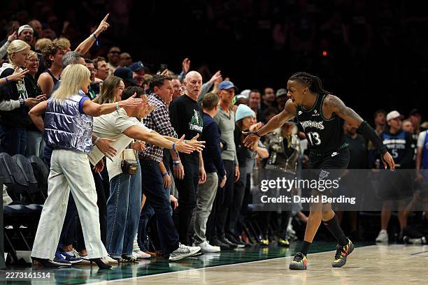 Ayo Dosunmu of the Minnesota Timberwolves celebrates with fans against the Denver Nuggets in the fourth quarter of Game Four of the First Round of...