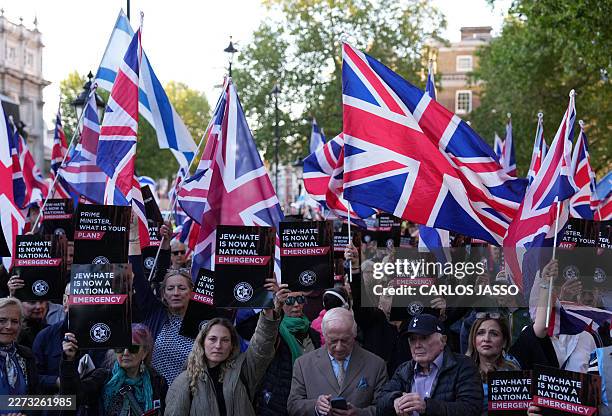 People attend a rally organised by the Campaign Against Antisemitism, opposite Downing Street in central London on April 30 following the stabbing of...